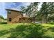 Large backyard showing the rear of the home, lawn, and screened-in pool at 21312 Marsh View Ct, Clermont, FL 34715