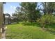 Exterior view of the pool and large backyard with mature trees and landscaping at 21312 Marsh View Ct, Clermont, FL 34715