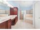 Luxurious bathroom featuring a double vanity, walk-in shower, and soaking tub at 21312 Marsh View Ct, Clermont, FL 34715