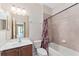 Well-lit bathroom with a single vanity, shower-tub combination, and access to other areas of the house at 21312 Marsh View Ct, Clermont, FL 34715