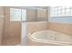 Bright bathroom with a luxurious soaking tub and a separate glass-enclosed shower at 21312 Marsh View Ct, Clermont, FL 34715