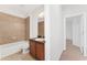 Bathroom featuring tiled shower/tub and vanity with storage, providing a comfortable and functional space at 21312 Marsh View Ct, Clermont, FL 34715