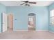 Bright bedroom showcases an arched doorway leading to a bathroom and large windows at 21312 Marsh View Ct, Clermont, FL 34715
