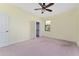 Bright bedroom featuring carpet, neutral walls, ceiling fan, and closet at 21312 Marsh View Ct, Clermont, FL 34715