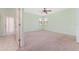 Bright bedroom with a ceiling fan, neutral carpet, and a view from the window at 21312 Marsh View Ct, Clermont, FL 34715