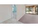 Bedroom with a view to another bedroom, carpet, and a sliding glass door at 21312 Marsh View Ct, Clermont, FL 34715