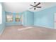 Sunlit bedroom boasting large windows and a ceiling fan for enhanced comfort and light at 21312 Marsh View Ct, Clermont, FL 34715