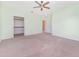 Bright bedroom featuring carpet, neutral walls, closet, and multiple doorways at 21312 Marsh View Ct, Clermont, FL 34715