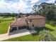 Rear exterior view of a two-story home, showing a large lawn and two car garage at 21312 Marsh View Ct, Clermont, FL 34715