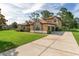 Beautiful home featuring a long driveway leading to a spacious two-car garage at 21312 Marsh View Ct, Clermont, FL 34715