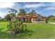 Beautiful home with a well-maintained lawn and unique plants adding character to the property at 21312 Marsh View Ct, Clermont, FL 34715