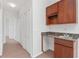 Hallway featuring a convenient wet bar with granite countertop and storage, enhancing functionality at 21312 Marsh View Ct, Clermont, FL 34715
