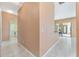 Hallway with tile flooring that leads to laundry room and sliding glass doors at 21312 Marsh View Ct, Clermont, FL 34715