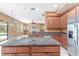 Open kitchen with island, stainless appliances, granite counters, blending style with functionality at 21312 Marsh View Ct, Clermont, FL 34715