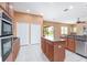 Updated kitchen with stainless steel appliances and granite countertops opens to the backyard at 21312 Marsh View Ct, Clermont, FL 34715