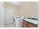 The laundry room has a washer, dryer, utility sink, and a storage closet at 21312 Marsh View Ct, Clermont, FL 34715