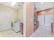 Bright laundry room with modern washer and dryer next to the kitchen area at 21312 Marsh View Ct, Clermont, FL 34715