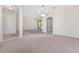 Open living room area with tile flooring, chandelier, and view to an adjacent room at 21312 Marsh View Ct, Clermont, FL 34715