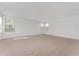 Large living room featuring neutral carpeting and abundant natural light from several windows at 21312 Marsh View Ct, Clermont, FL 34715