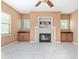 Bright living room featuring tile flooring, large windows, a fireplace, and built-in cabinets at 21312 Marsh View Ct, Clermont, FL 34715