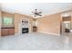 Open living room features tile floors, a ceiling fan, a fireplace, and built-in cabinets at 21312 Marsh View Ct, Clermont, FL 34715