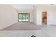 Living room featuring tile, carpet flooring and a large sliding door leading to the pool at 21312 Marsh View Ct, Clermont, FL 34715