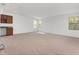 Spacious living room featuring neutral carpeting, natural light from multiple windows, and a convenient wet bar at 21312 Marsh View Ct, Clermont, FL 34715