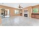 Bright living room with tiled floor, multiple windows, fireplace and wet bar leading to kitchen area at 21312 Marsh View Ct, Clermont, FL 34715