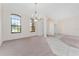 Spacious living area featuring carpet and a large window with natural light at 21312 Marsh View Ct, Clermont, FL 34715
