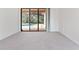 Bright living room with large sliding glass doors that open to the pool area at 21312 Marsh View Ct, Clermont, FL 34715