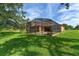 View of the screened in pool with a beautiful green lawn surrounding the enclosure at 21312 Marsh View Ct, Clermont, FL 34715
