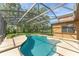 Beautiful in-ground pool with a large screened-in lanai and outdoor space at 21312 Marsh View Ct, Clermont, FL 34715