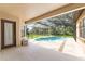 Screened-in pool area with beautiful views of the landscaped backyard at 21312 Marsh View Ct, Clermont, FL 34715