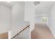 Upstairs hallway with carpeting, neutral paint, and natural light at 21312 Marsh View Ct, Clermont, FL 34715