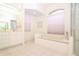This spacious bathroom features a separate tub, shower, dual sinks, and bright, natural light at 22125 Draw Bridge Dr, Leesburg, FL 34748