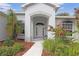 Inviting covered front porch with elegant archway, decorative plants, and cozy bench seating at 22125 Draw Bridge Dr, Leesburg, FL 34748