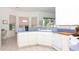 Bright kitchen featuring white appliances, a cozy breakfast nook, and abundant counter space at 22125 Draw Bridge Dr, Leesburg, FL 34748