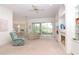 Bright living room featuring a fireplace, built-in shelving, and sliding glass doors leading to the backyard at 22125 Draw Bridge Dr, Leesburg, FL 34748