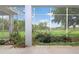 View of spacious lanai with lush landscaping and a serene outdoor view from the screened-in patio at 22125 Draw Bridge Dr, Leesburg, FL 34748