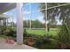 View of spacious lanai with lush landscaping and a serene outdoor view from the screened-in patio at 22125 Draw Bridge Dr, Leesburg, FL 34748