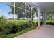 View of spacious lanai with lush landscaping and a serene outdoor view from the screened-in patio at 22125 Draw Bridge Dr, Leesburg, FL 34748