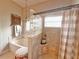 Modern bathroom with a shower and tub combo featuring a glass block wall at 2299 Twickingham Ct, Clermont, FL 34711