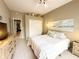Bright bedroom with a neutral color palette, tile flooring, and a well-lit closet at 2299 Twickingham Ct, Clermont, FL 34711