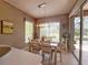 Bright dining area featuring a stylish light fixture and outdoor views at 2299 Twickingham Ct, Clermont, FL 34711