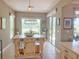 Bright dining room features pendant lighting and easy access to the outdoors at 2299 Twickingham Ct, Clermont, FL 34711