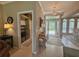 Entryway with tiled floors, a chandelier, a console table, and access to the laundry room at 2299 Twickingham Ct, Clermont, FL 34711