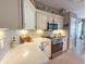 Modern kitchen features white cabinets, stainless appliances, and tile backsplash at 2299 Twickingham Ct, Clermont, FL 34711
