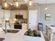 This updated kitchen features white cabinetry, stainless appliances, and light countertops at 2299 Twickingham Ct, Clermont, FL 34711