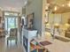 This eat-in kitchen features stainless appliances, light countertops and tile backsplash, and a breakfast bar at 2299 Twickingham Ct, Clermont, FL 34711