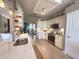 Modern kitchen features stainless appliances, light countertops and tile backsplash, and lots of natural light at 2299 Twickingham Ct, Clermont, FL 34711
